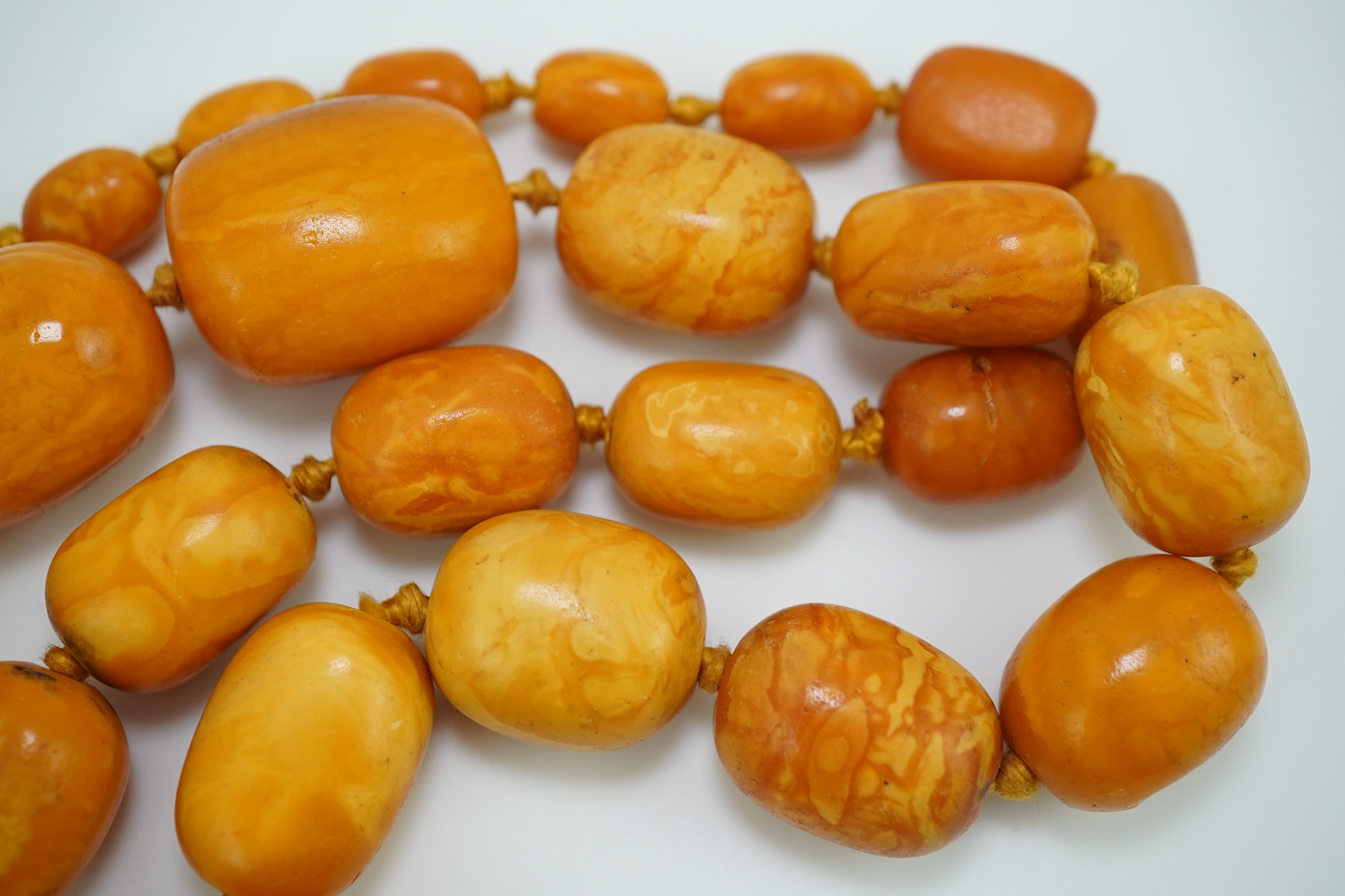 A single strand graduated oval amber bead necklace